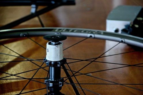 Bicycle wheel placed on a table, showing the spokes in detail